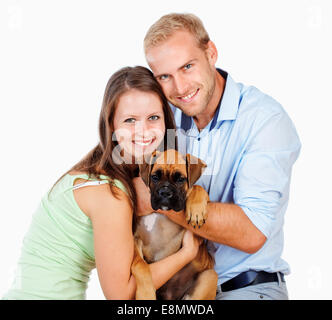 Portrait of a Happy Young Couple with a Dog. Stock Photo