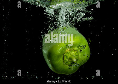Green pepper floating in water Stock Photo