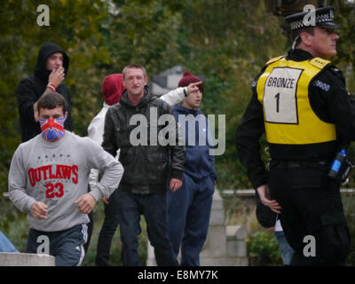 A member of the English Defence League, with his face covered leads a group of EDL members from the steps of Portsmouth guildhall  during a protest against the building of an Islamic school in Portsmouth, England Stock Photo