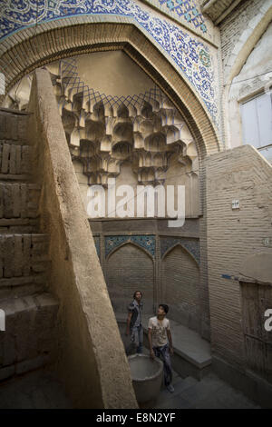 Isfahan, Iran. 11th Oct, 2014. October 11, 2014 - Isfahan, Iran - Two Iranian men look on a historical building located in Isfahan Traditional Grand Bazaar, 450 km (281 miles) south of Tehran. Traditional Grand Bazaar is a historical market in the city of Isfahan also is one of the oldest and largest bazaars in the Middle East which is dating back to the 17th century. The bazaar with 2 Km length is the main connection between the old city with the new. Morteza Nikoubazl/ZUMAPRESS © Morteza Nikoubazl/ZUMA Wire/Alamy Live News Stock Photo