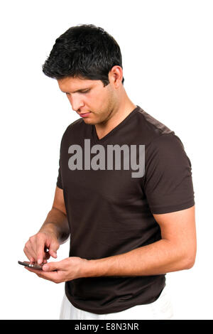 Young man sends a message by texting on his smartphone. Stock Photo