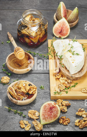 Fresh Figs with Spiced Honey and Goat Cheese. Done with a vintage retro filter. Macro, selective focus Stock Photo