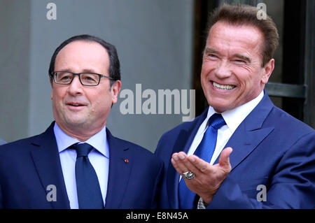 Paris, France. 10th Oct, 2014. French President Francois Hollande welcomes US actor, former governor of California and founding chair of the R20 initiative Arnold Schwarzenegger prior to their meeting at the Elysee Palace on October 10, 2014 in Paris, France. Schwarzenegger's R20 organisation, a coalition of partners led by regional governments working against climate change, is holding a two-day summit in Paris Credit:  dpa/Alamy Live News Stock Photo