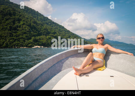 Topless woman sunbathing on a boat Stock Photo: 4194740 