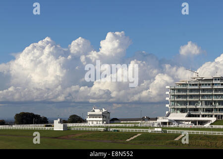 Epsom Downs, Surrey, UK. 11th October 2014. Blue skies alternate with dramatic cumulonimbus rain clouds over Epsom Downs Race Course. Here the clouds tower over the old Prince's Pavilion built in 1879. Credit:  Julia Gavin UK/Alamy Live News Stock Photo