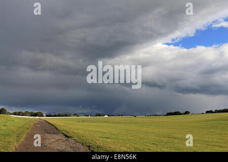 Epsom Downs, Surrey, UK. 11th October 2014. Blue skies alternate with dramatic cumulonimbus rain clouds over Epsom Downs Race Course. Credit:  Julia Gavin UK/Alamy Live News Stock Photo