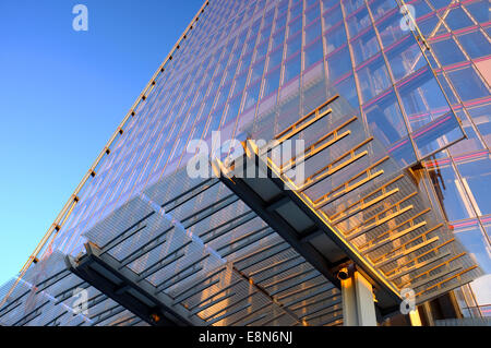 The Shard building in London reflects the pink sunset golden hour glow against a blue sky at dusk Stock Photo