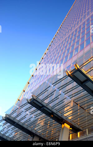 The Shard building in London reflects the pink sunset golden hour glow against a blue sky at dusk Stock Photo