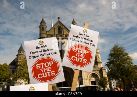 Belfast, Northern Ireland. 11th Oct, 2014.  Stop the Cuts placard from the Irish order of Thelema with St Anne's Cathedral  in the Background Credit:  Bonzo/Alamy Live News Stock Photo