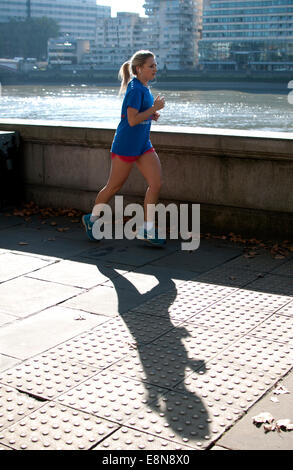 Female runner on Victoria Embankment, London, UK Stock Photo
