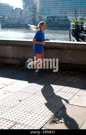 Female runner on Victoria Embankment, London, UK Stock Photo