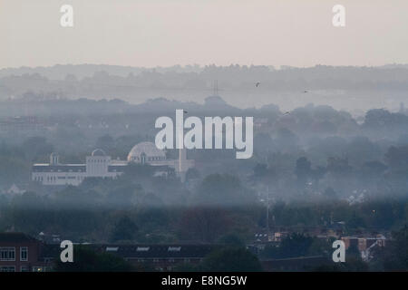 Wimbledon, London, UK. 12th October, 2014. UK weather. The Baitul Futuh mosque rises above a band of early mist covering the landscape in south west © amer ghazzal/Alamy Live News Stock Photo