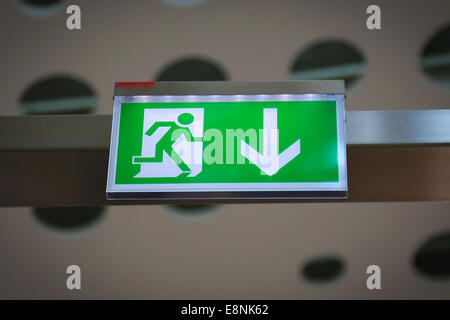 Emergency exit sign above a black doorway Stock Photo