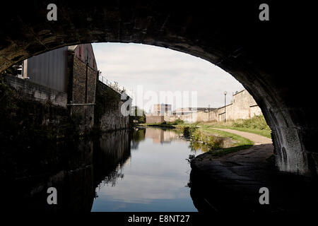 Canal bridge with factories behind in Blackburn on the Leeds and Liverpool canal Stock Photo