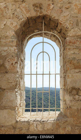 window of an old fortress with a lattice Stock Photo
