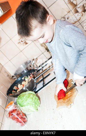 wounded in the left hand with bandage boy at shot in home kitchen Stock Photo