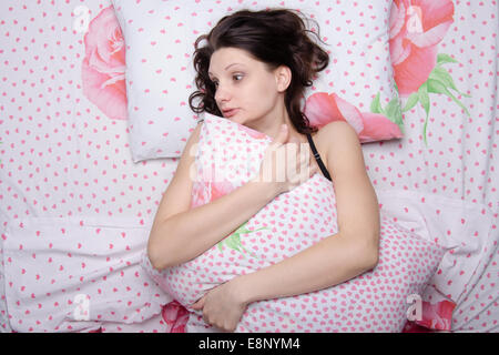 Young beautiful girl sleeping alone in bed Stock Photo