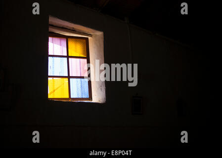 Coloured glass window with black background. Stock Photo