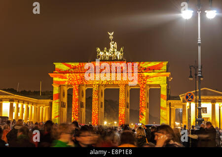 a lot of people admire at the Festival of Lights, the illuminated Brandenburg Gate in Berlin editorial use Stock Photo