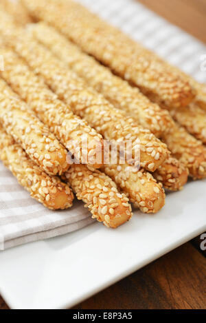 Bread sticks with sesame seeds on plate closeup Stock Photo