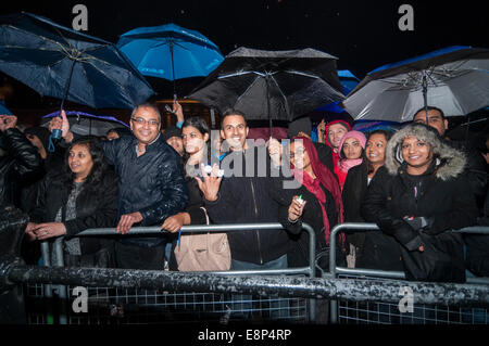 London, UK, 12th October, 2014.  Even though there was heavy rain, thousands gathered in Trafalgar Square to celebrate the annual Diwali Festival and to enjoy stage performances of traditional and contemporary music and dance.    Credit:  Stephen Chung/Alamy Live News Stock Photo