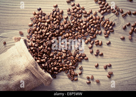 the coffee beans spill out of the sack Stock Photo