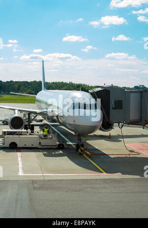 Passenger plane maintenance in airport before flight. Stock Photo