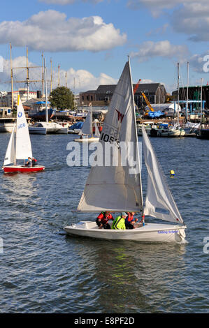 Bristol City Docks have become a tourist and activity area. Dinghies sailing in harbour by marina. UK Stock Photo