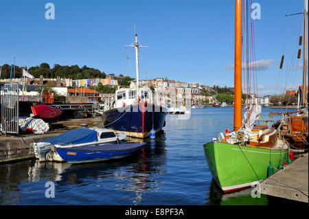 Bristol City Docks flouting harbour, boats moored in Underfall Yard with Hotwells and city centre further down the harbour, UK Stock Photo