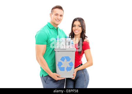 Young couple holding a recycle bin isolated on white background Stock Photo