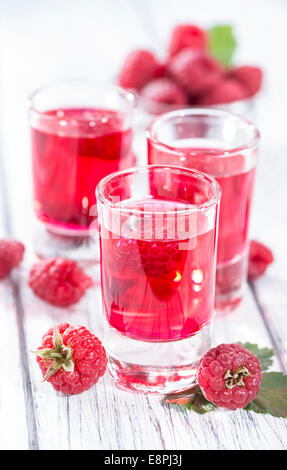 Glass with Raspberry Liqueur and some fresh fruits Stock Photo