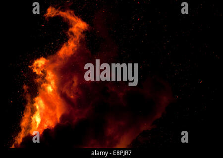 Large bonfire against a black night's sky making incredible shapes Stock Photo