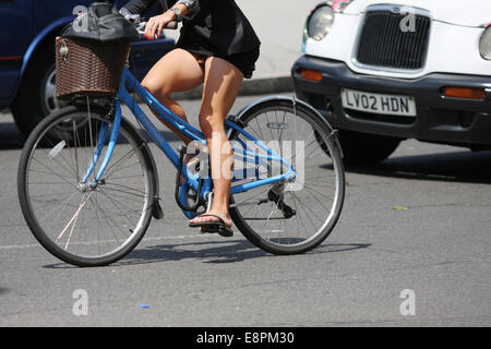 riding her bike with flip flops Stock 