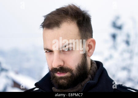 Portrait of a young man in the winter raising an eyebrow Stock Photo