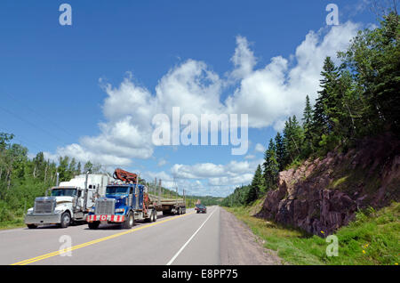 Cargo truck on Trans Canada Highway under cloud blue sky Stock Photo