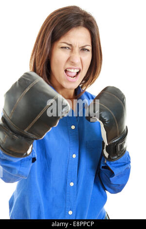 Fearless and furious young businesswoman in boxing concept with black gloves, fight face expression Stock Photo