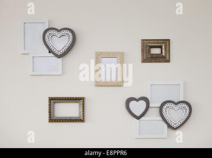 Set of white and golden vintage antique frames on th light wall Stock Photo