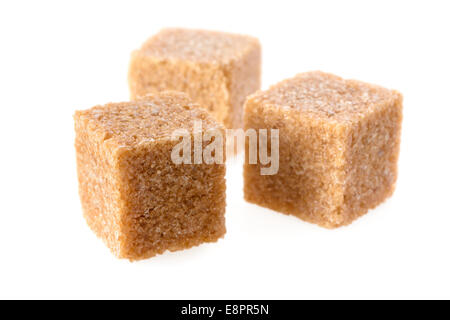 Food: group of three cane sugar cubes, isolated on white background Stock Photo