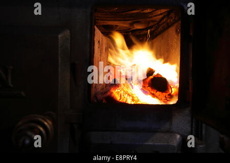 Fire burning in an old wood stove. Stock Photo