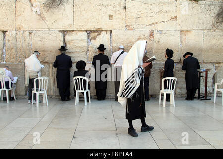 Jewish worshipers pray at the Western Wall  in East Jerusalem Stock Photo