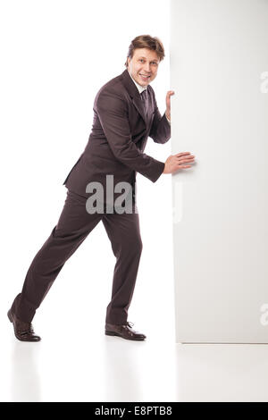 Business man holding empty board and pointing Stock Photo