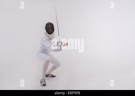 Young woman engaging in fencing Stock Photo