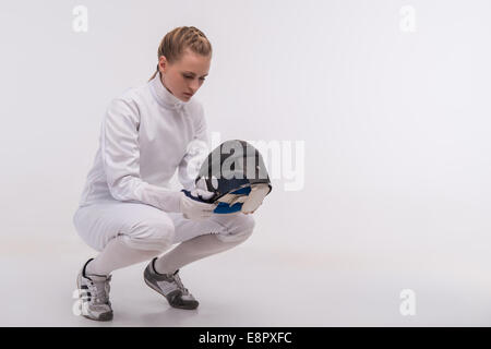 Young woman engaging in fencing Stock Photo