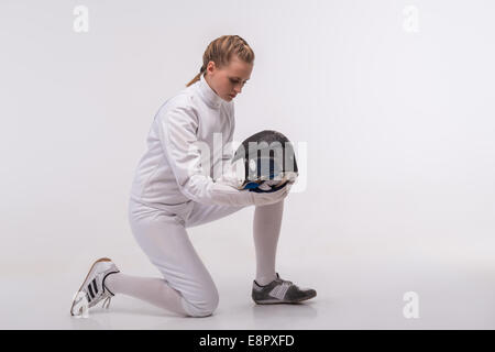 Young woman engaging in fencing Stock Photo