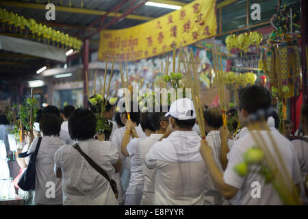 Worshippers take part in a procession from Saan Jao Joe Sue Gong temple during the annual Vegetarian Festival, Bangkok, Thailand Stock Photo