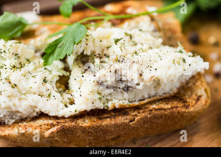 Toast with scrambled eggs on a wooden board with parsley Stock Photo