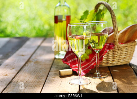 Cheese, grapes, bread and two glasses of the white wine outdoors Stock Photo