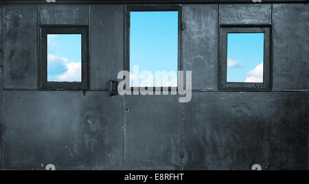 Three small windows in the metal room Stock Photo