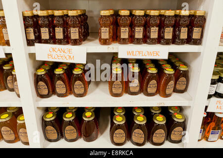 Wild flower and orange blossom honeys on shelf at farmers market - Pennsylvania USA Stock Photo