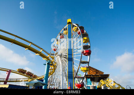 The roller coaster & ferris wheel in Pacific Park Amusement Park on Santa Monica Pier, Los Angeles, California, USA Stock Photo